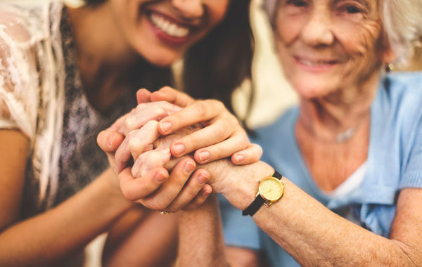 Older and Younger Women Holding Hands